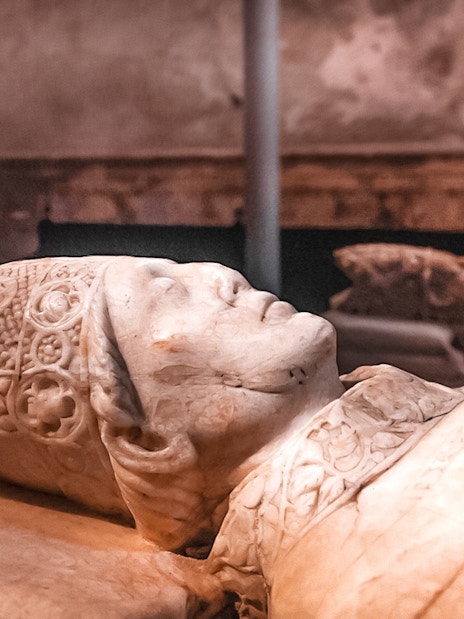 Stone effigy inside the Cathedral of Toledo during a guided tour.