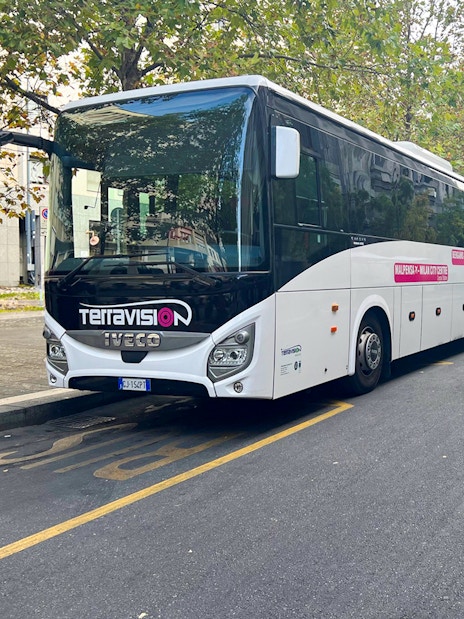 Terravision bus parked on a street, offering round-trip service between Ciampino Airport and Rome city center.