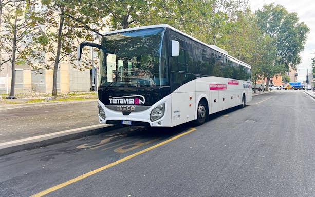Terravision bus parked on a street, offering round-trip service between Ciampino Airport and Rome city center.