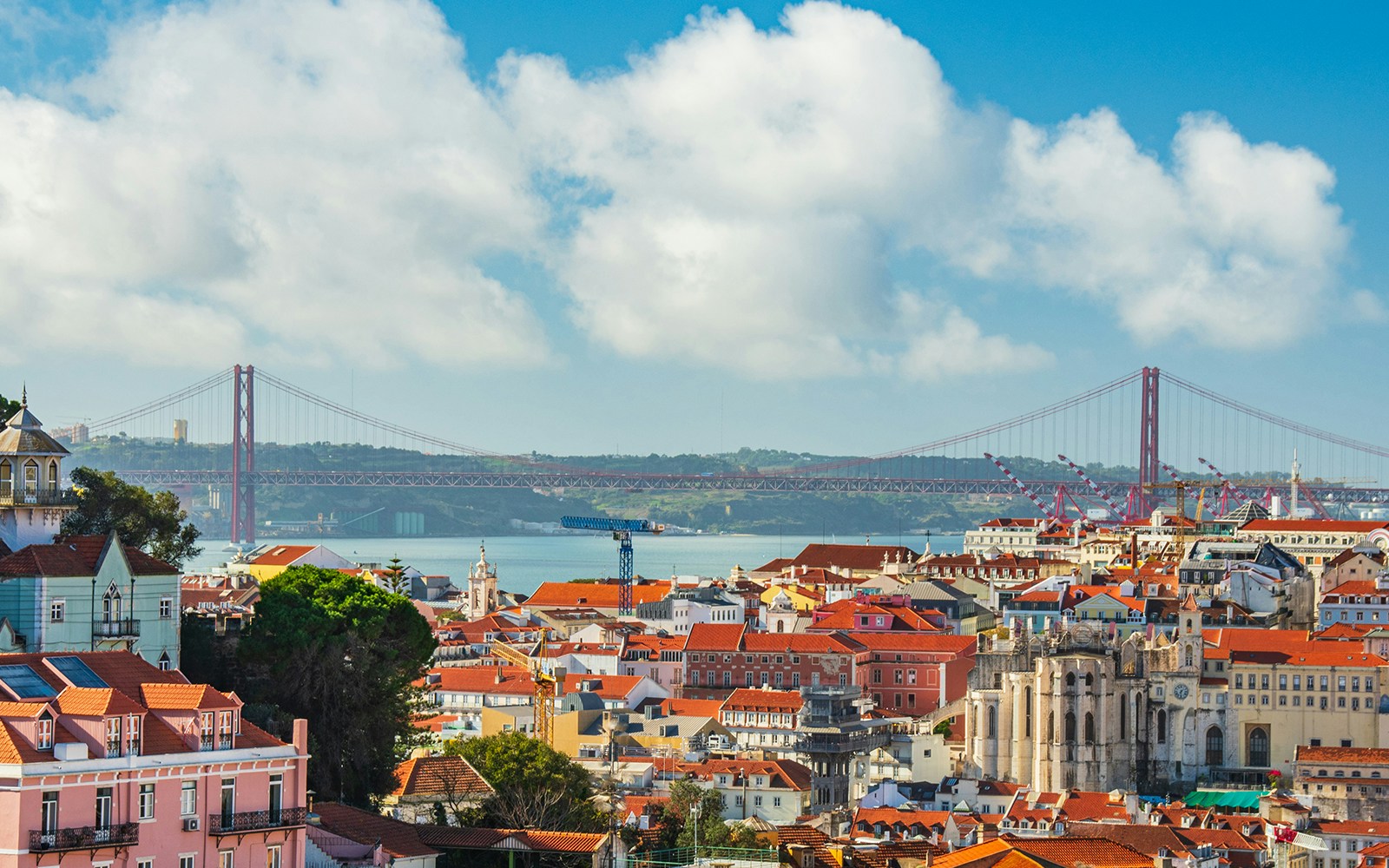 Lisbon Cathedral balcony overlooking cityscape with historic buildings and river view.