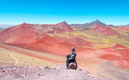 Man photographing Rainbow Mountain landscape in Peru.