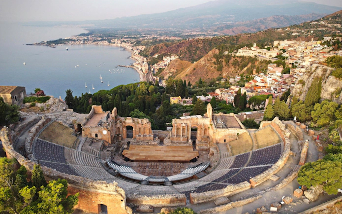 Ancient Greek theatre overlooking the coastline in Taormina, Sicily, Italy.