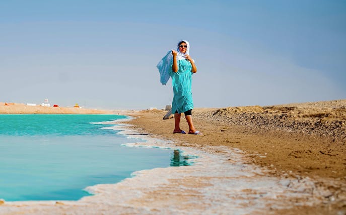 Person walking along the salt flats of Al Wathba, Abu Dhabi.