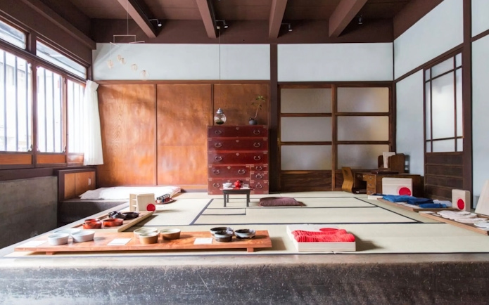 Traditional Japanese tea ceremony room with tatami mats and tea utensils.