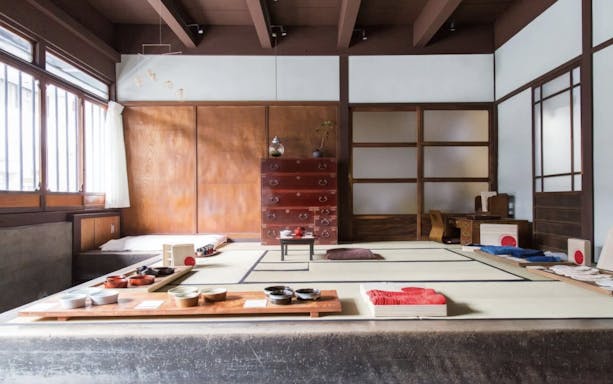 Traditional Japanese tea ceremony room with tatami mats and tea utensils.