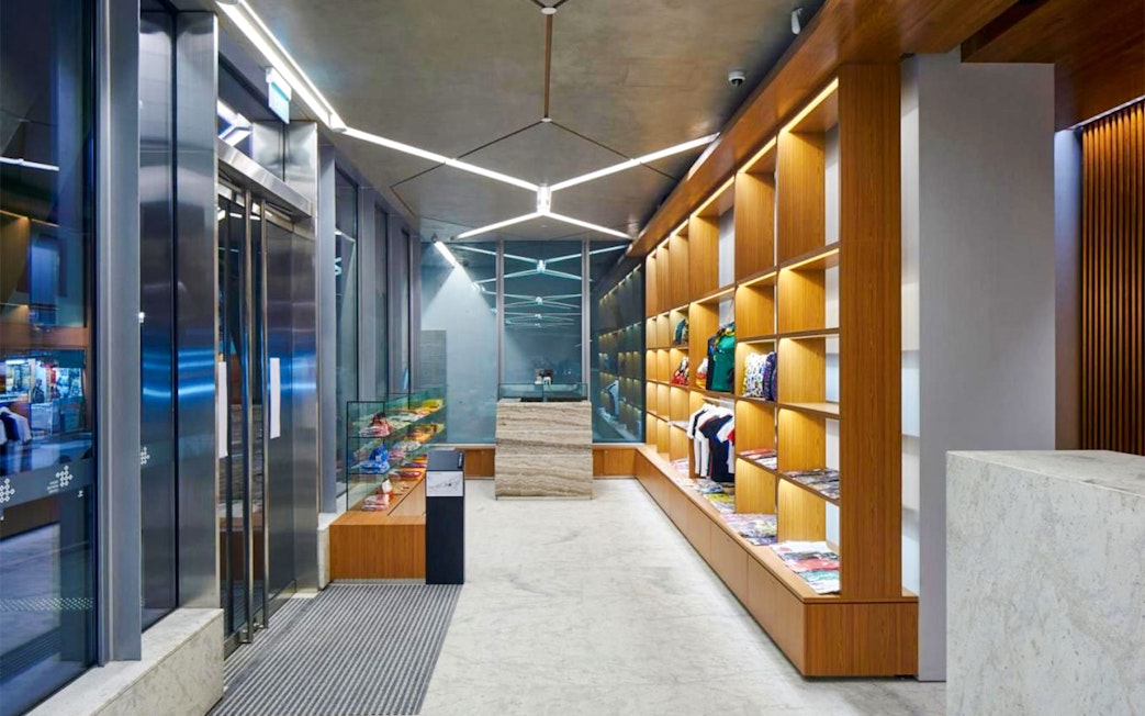 Lobby and gift shop of Indian Heritage Centre with wooden shelves displaying items.