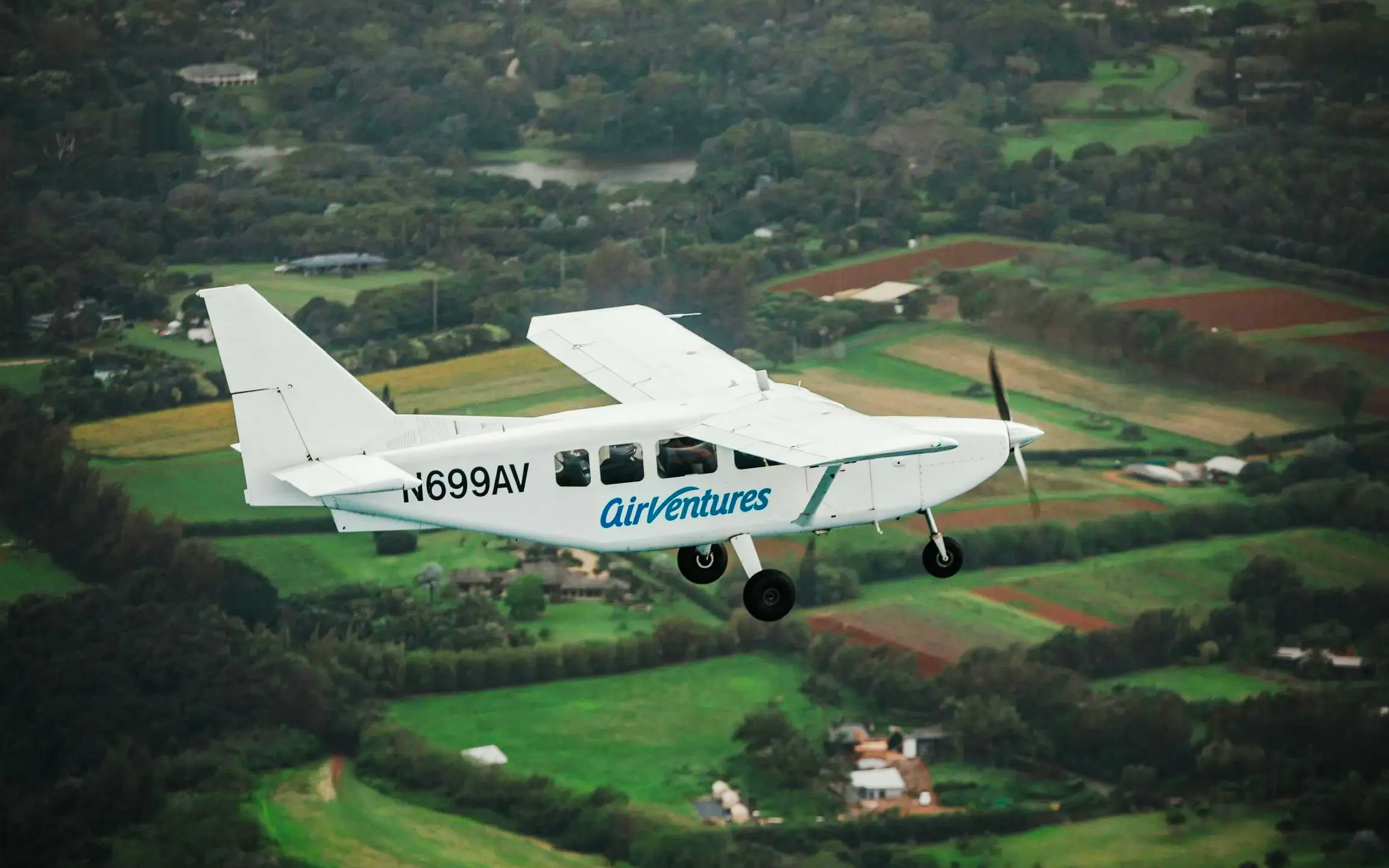 Small plane flying over lush landscapes on a private Kauai air tour.