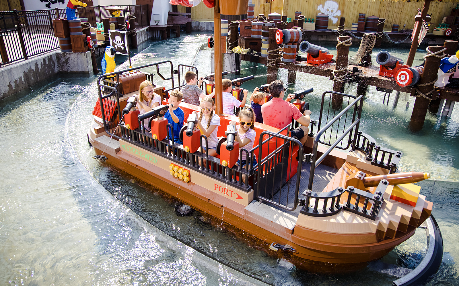 Guests enjoying a pirate-themed boat ride at Legoland, New York.