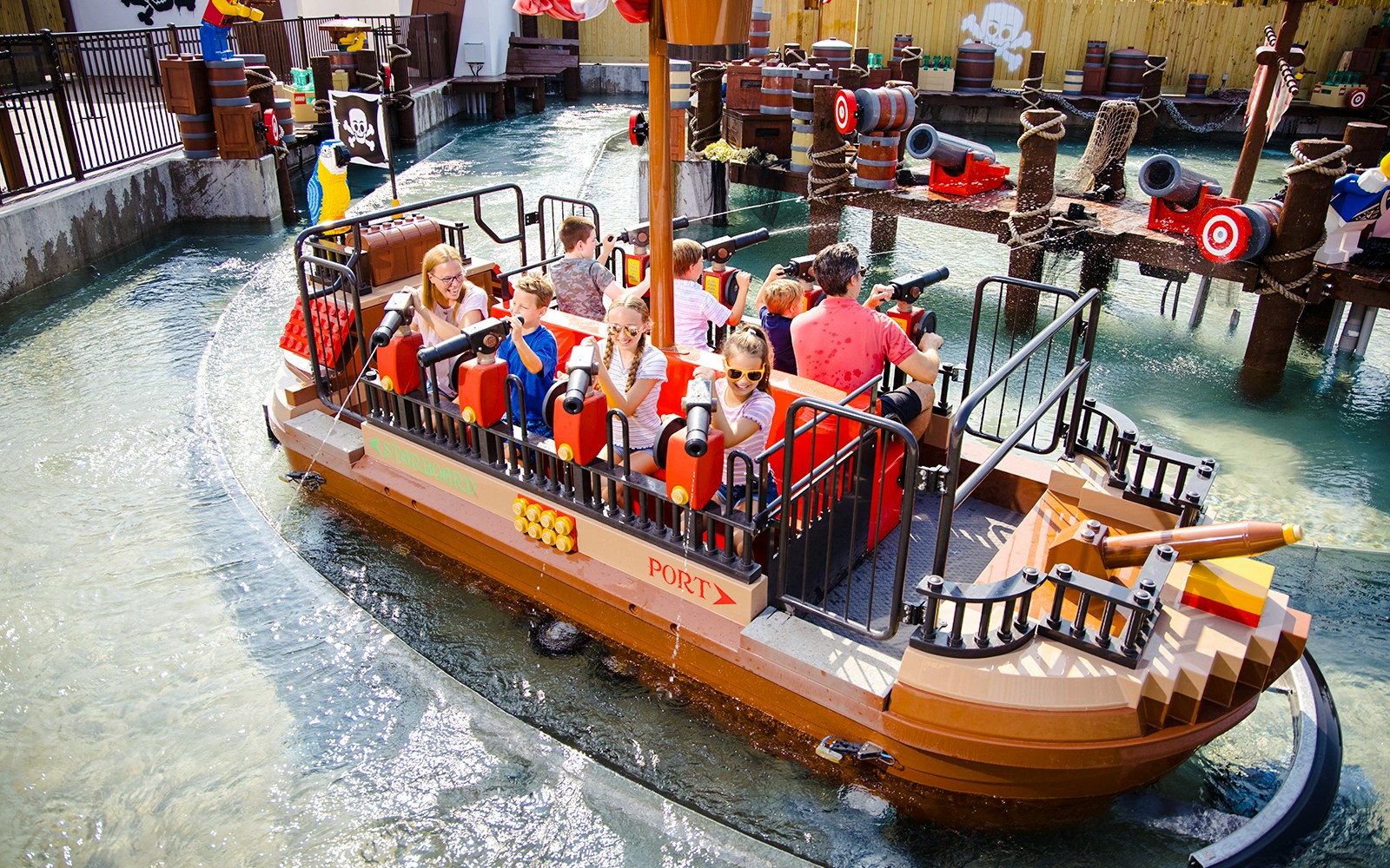 Guests enjoying a pirate-themed boat ride at Legoland, New York.