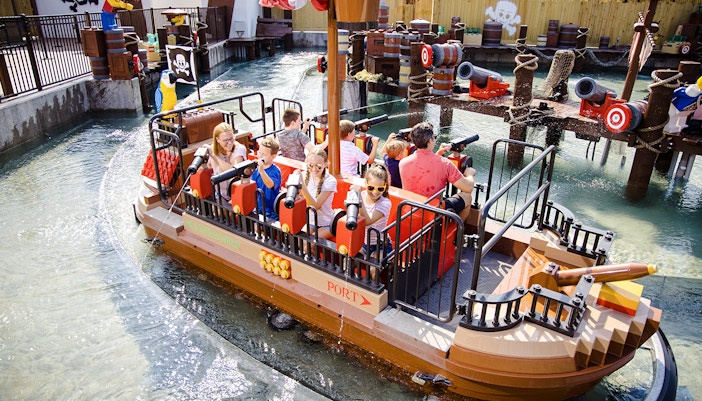 Guests enjoying a pirate-themed boat ride at Legoland, New York.