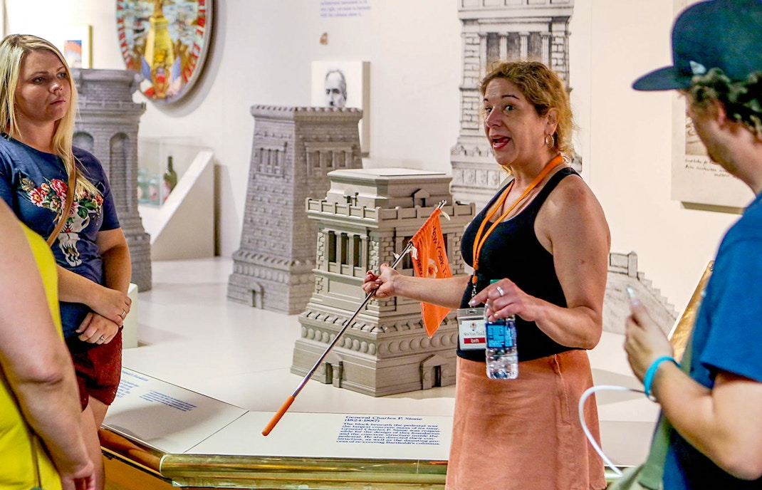 Guide explaining exhibits inside the Statue of Liberty Museum, New York City.