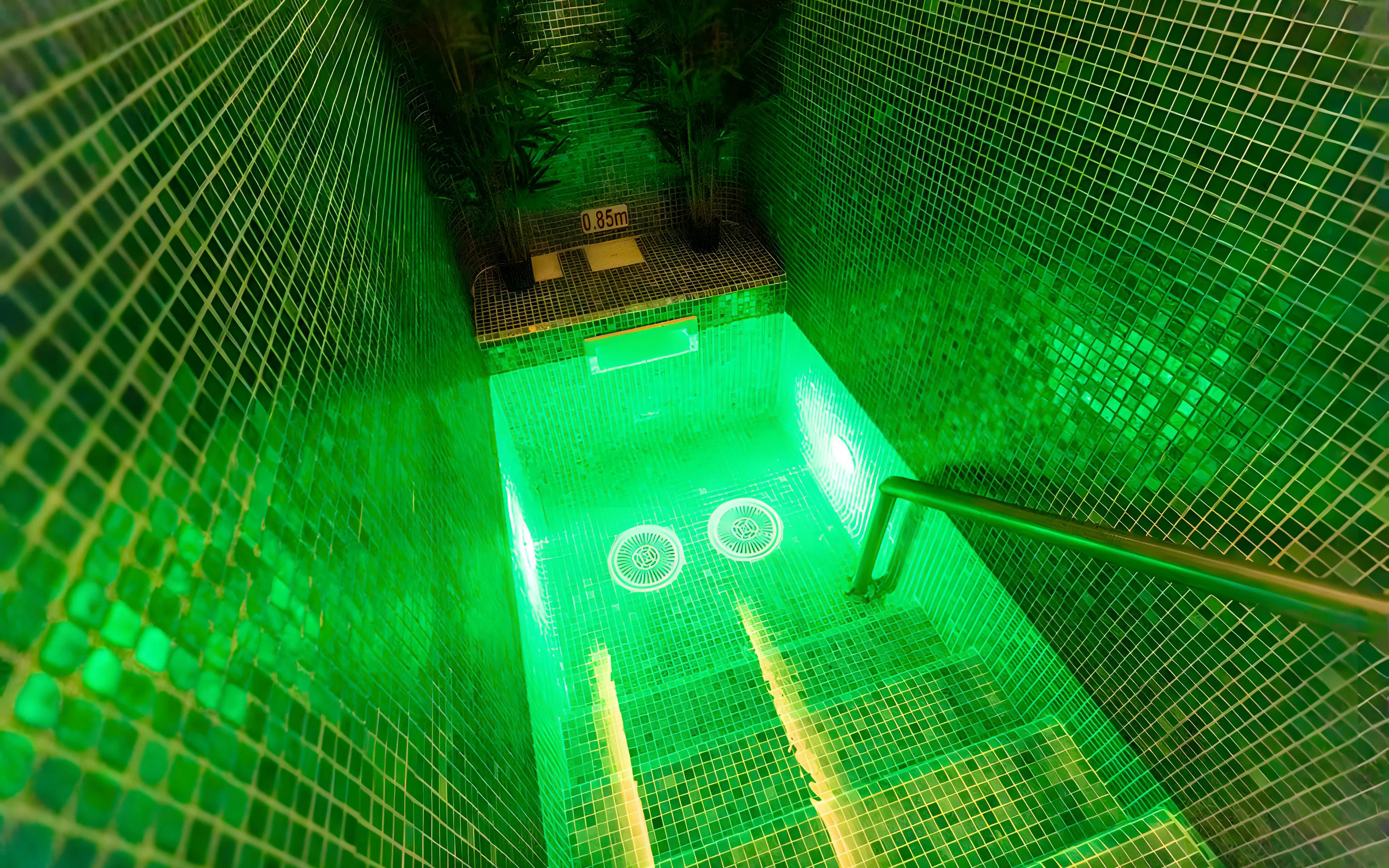Staircase leading to illuminated pool area at Aquashow Indoor Park.