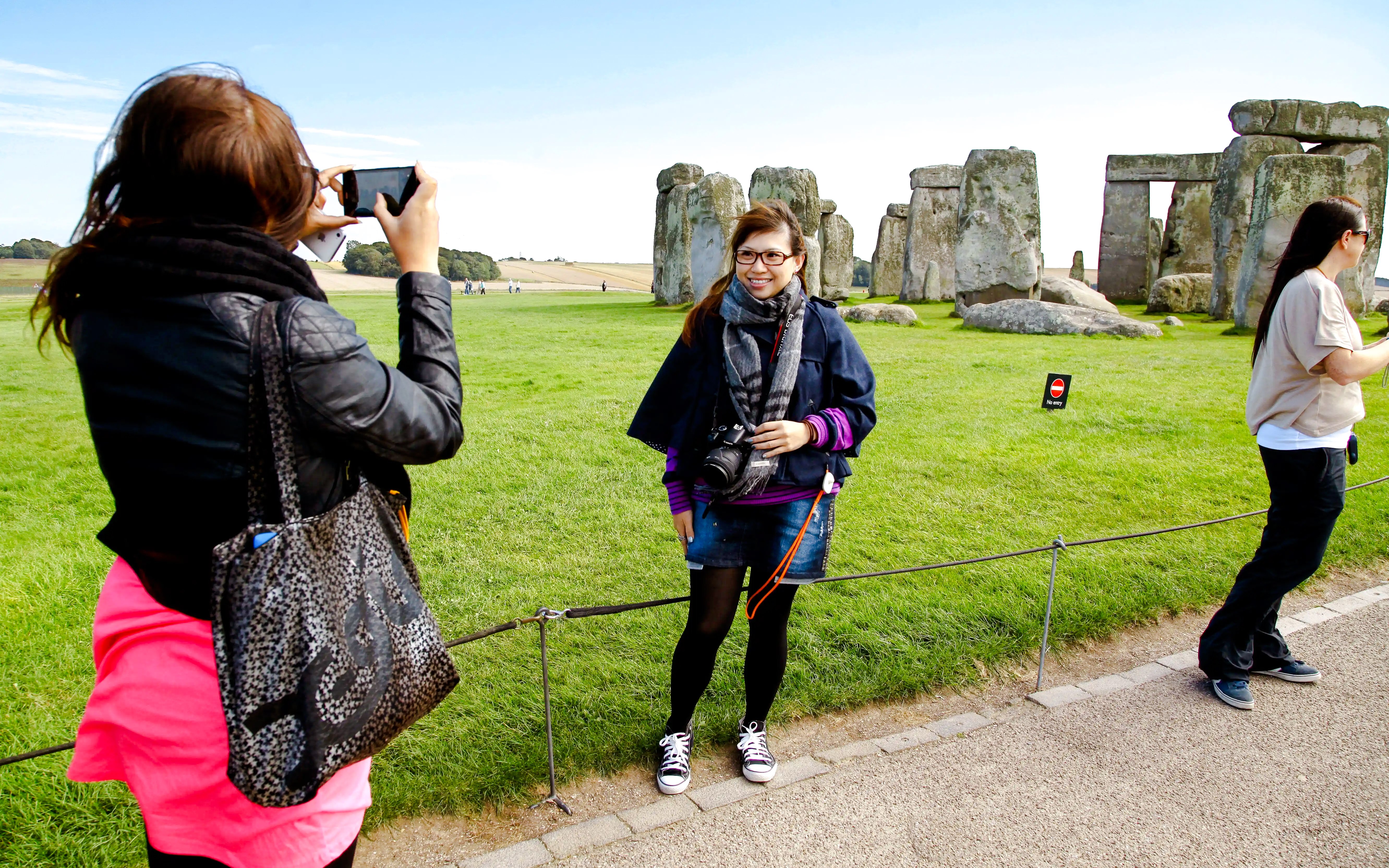 Visitors taking photos at Stonehenge, England.