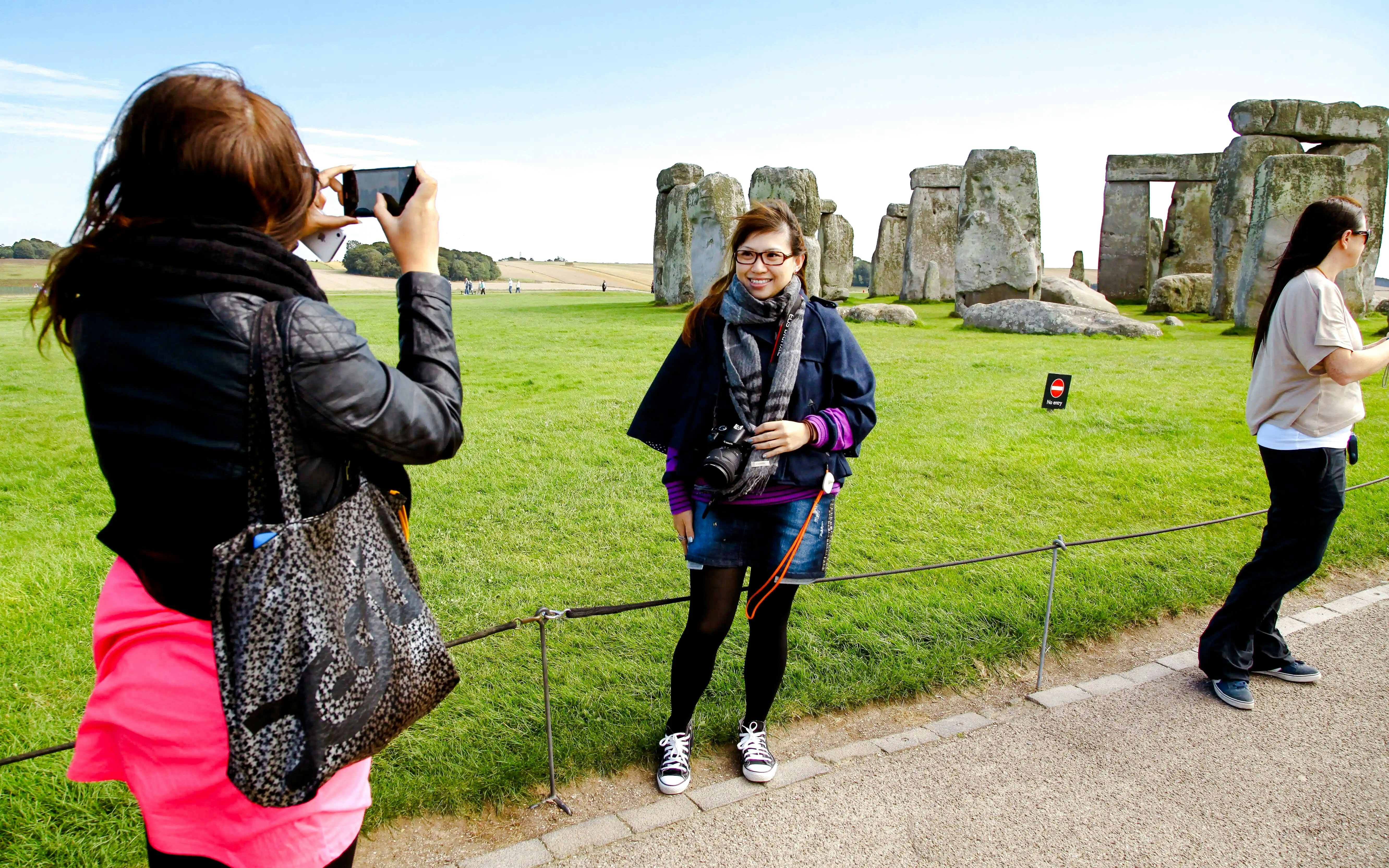 Visitors taking photos at Stonehenge, England.