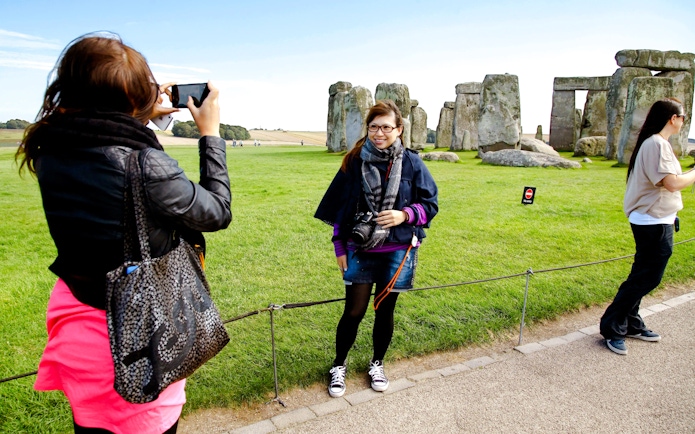 Visitors taking photos at Stonehenge, England.