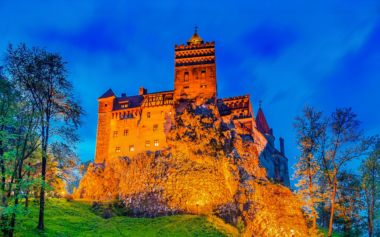 Dracula's Castle illuminated at night in Transylvania, Romania.