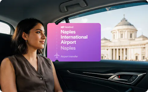 Private car transfer from Naples International Airport with view of city landmark.