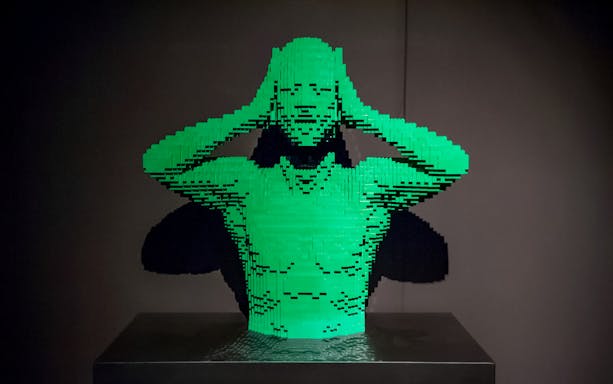 Lego sculpture of a person holding their head, featured in Australia: The Art of the Brick.