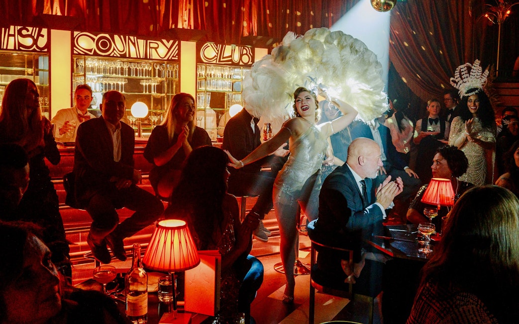 Cabaret performance at 58th Street club with dancers and audience.