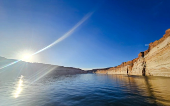 Sunrise over water in Antelope Canyon, Page, with sandstone cliffs reflecting in the lake.