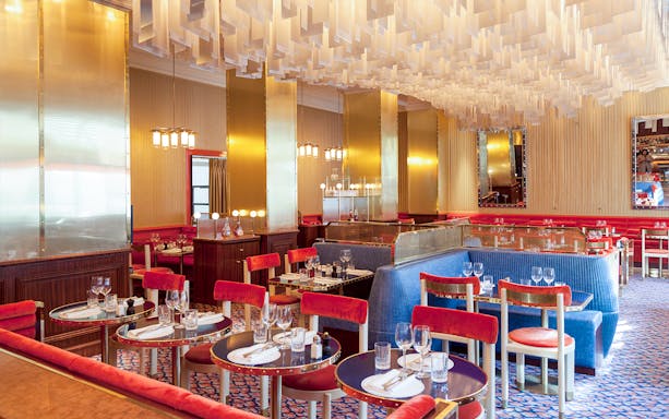 Breakfast setup at Opéra-Grand Café Capucines, Paris with elegant red and blue seating.