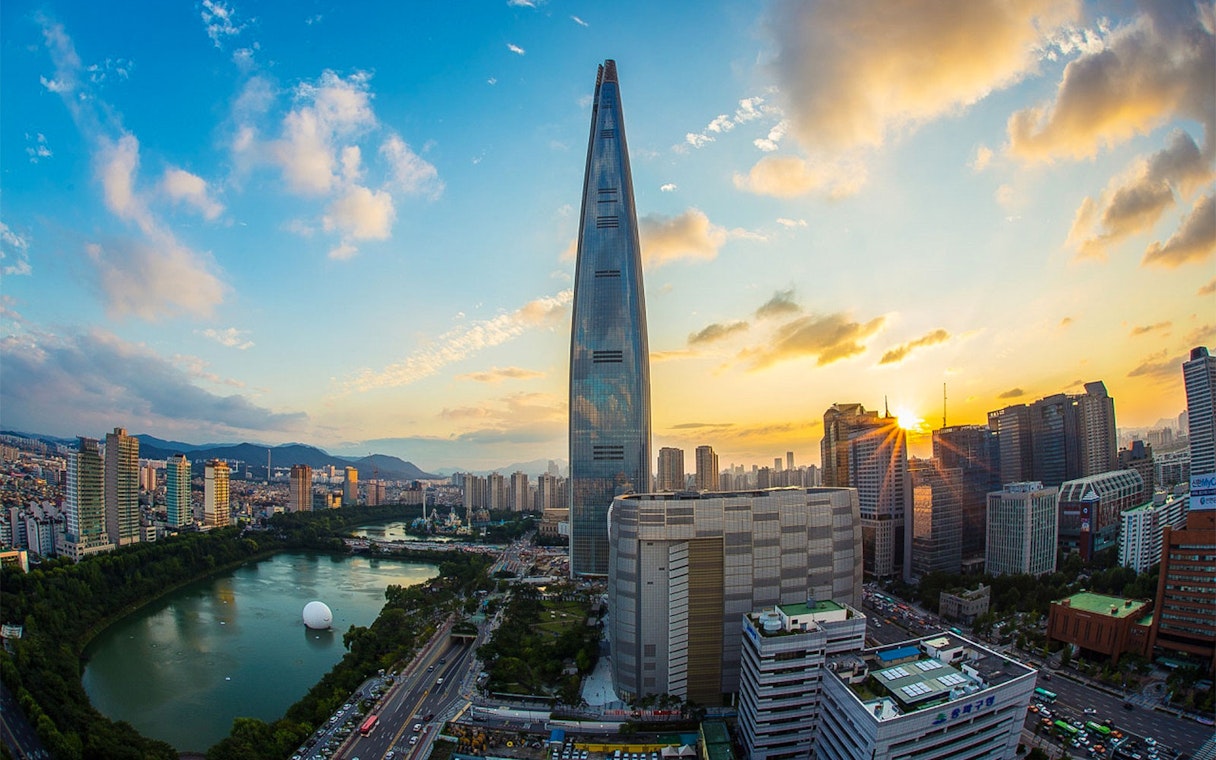 Lotte World Tower at sunset in Seoul, overlooking the city skyline and Han River.