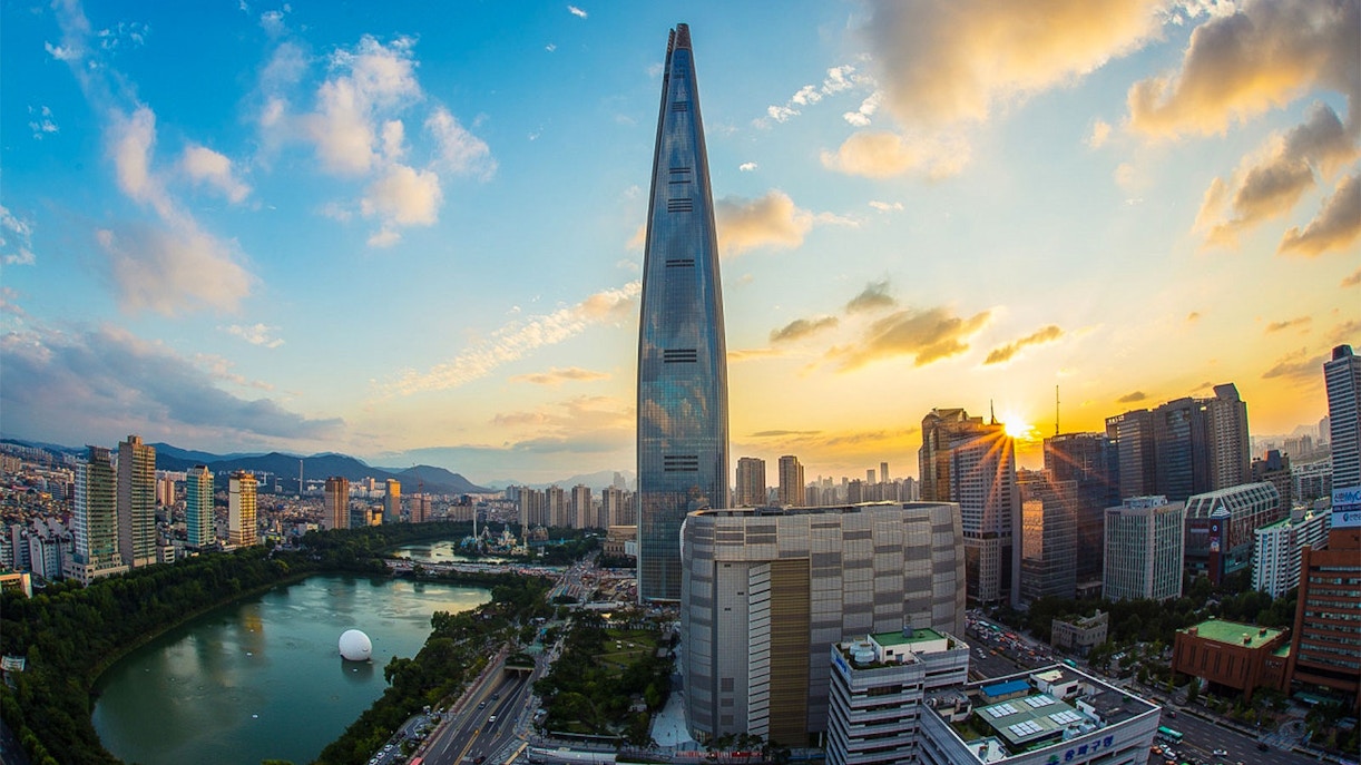 Lotte World Tower at sunset in Seoul, overlooking the city skyline and Han River.