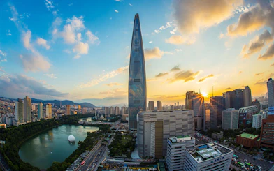 Lotte World Tower at sunset in Seoul, overlooking the city skyline and Han River.