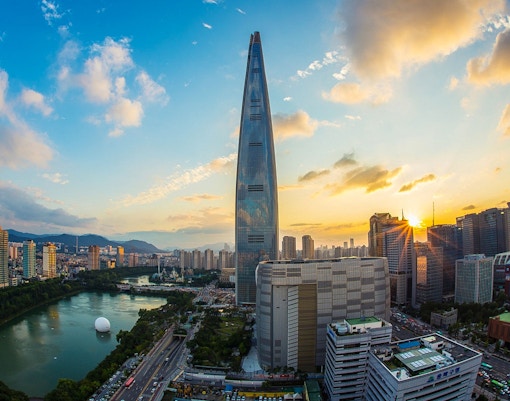Lotte World Tower at sunset in Seoul, overlooking the city skyline and Han River.