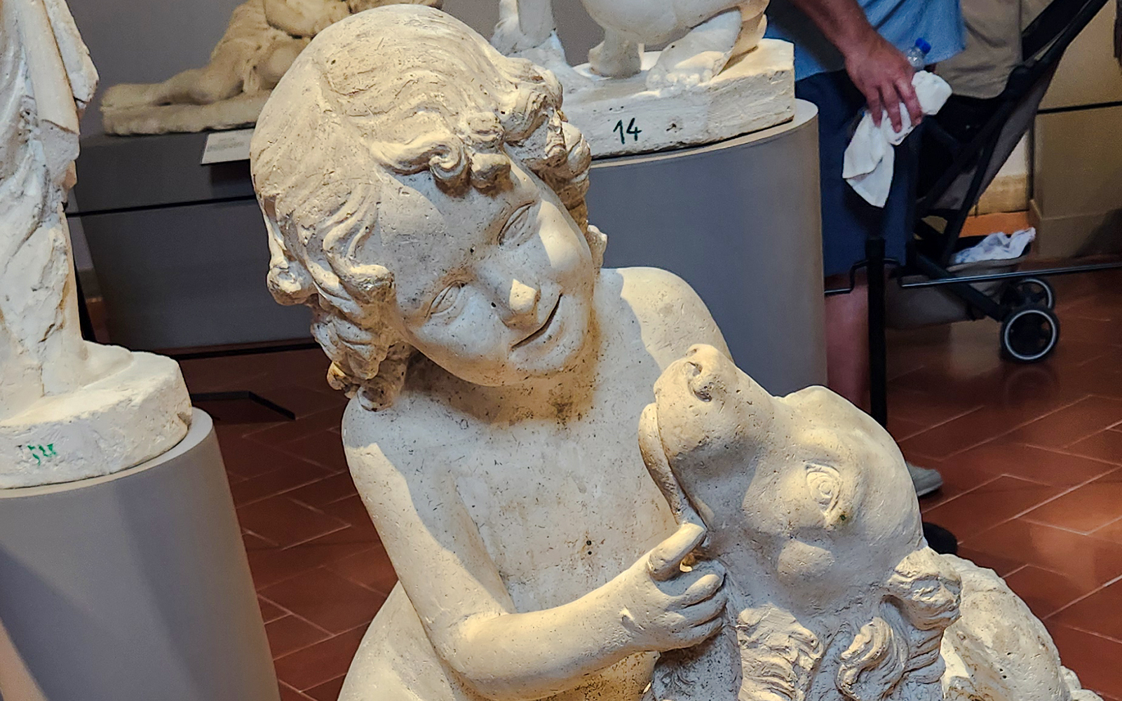 Sculpture of a child with a dog by Luigi Pampaloni in Accademia Gallery.