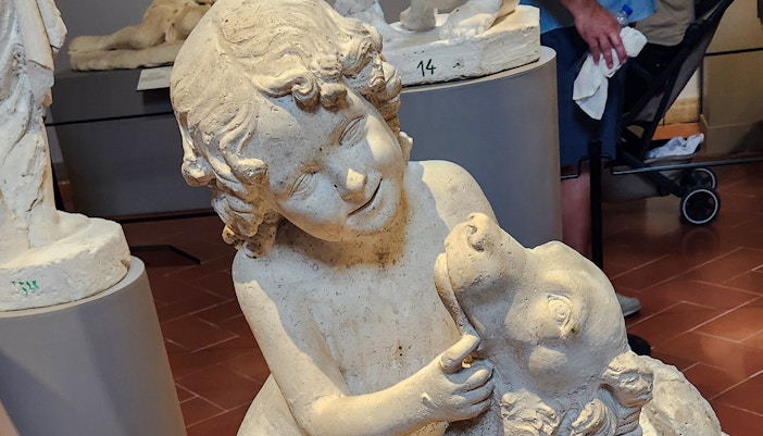 Sculpture of a child with a dog by Luigi Pampaloni in Accademia Gallery.