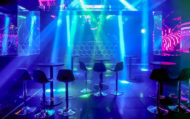 KITSUNE Kyoto Nightclub interior with vibrant lights and seating arrangement.