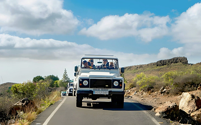 Jeep convoy on a scenic road during Gran Canaria safari tour.