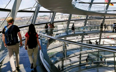 Visitors walking inside the glass dome of the Reichstag in Berlin.