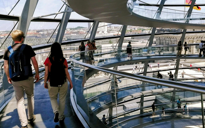 Visitors walking inside the glass dome of the Reichstag in Berlin.