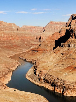 Grand Canyon view with Colorado River winding through rocky landscape.