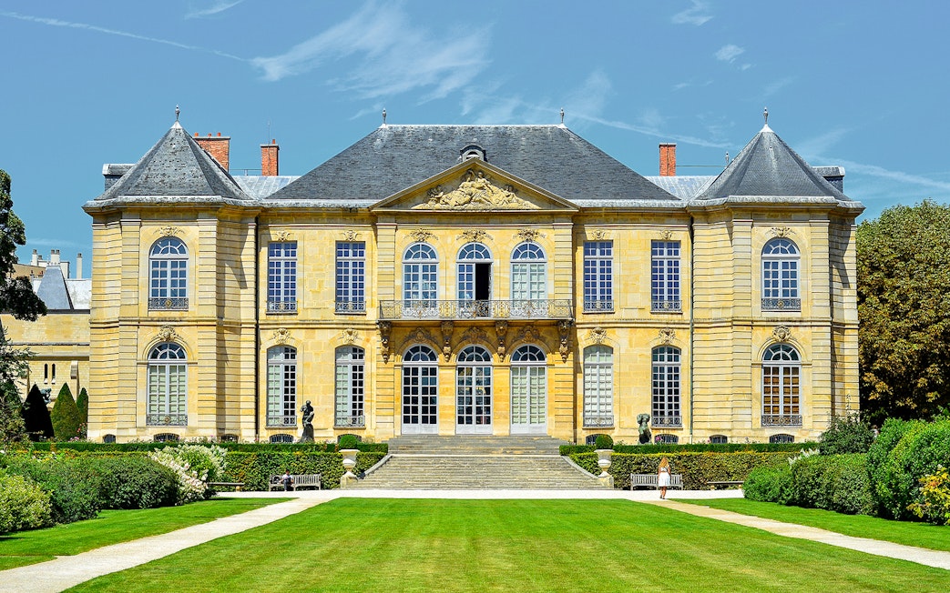 Rodin Museum exterior in Paris with garden path leading to entrance.