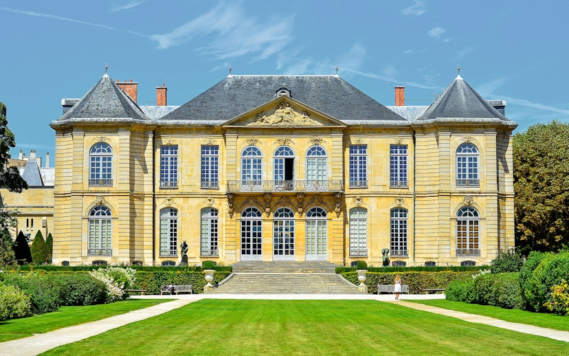 Rodin Museum exterior in Paris with garden path leading to entrance.