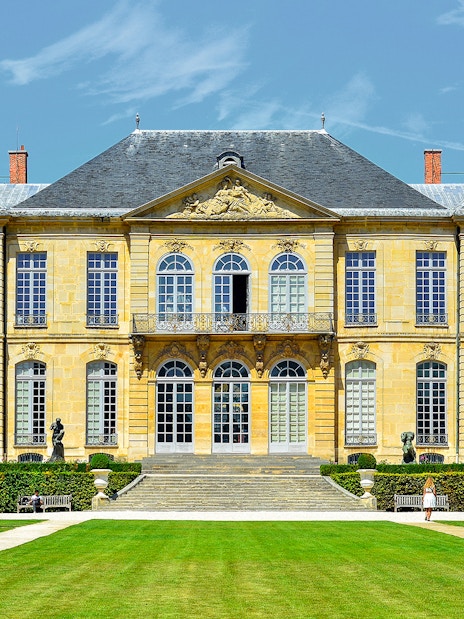 Rodin Museum exterior in Paris with garden path leading to entrance.