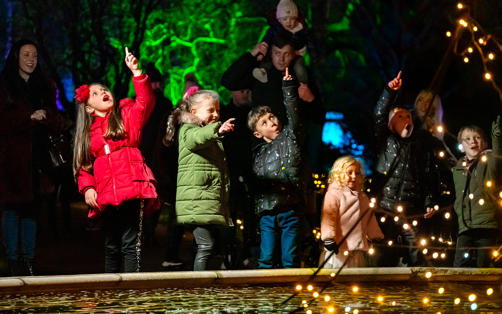 Children pointing at lights during Warwick Castle Light Trail.