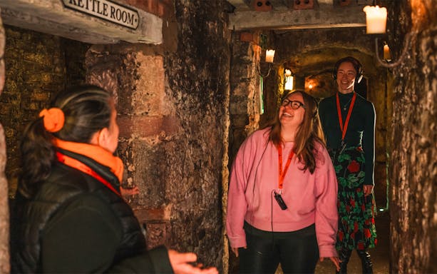 Guide leading guests through historic underground vaults.