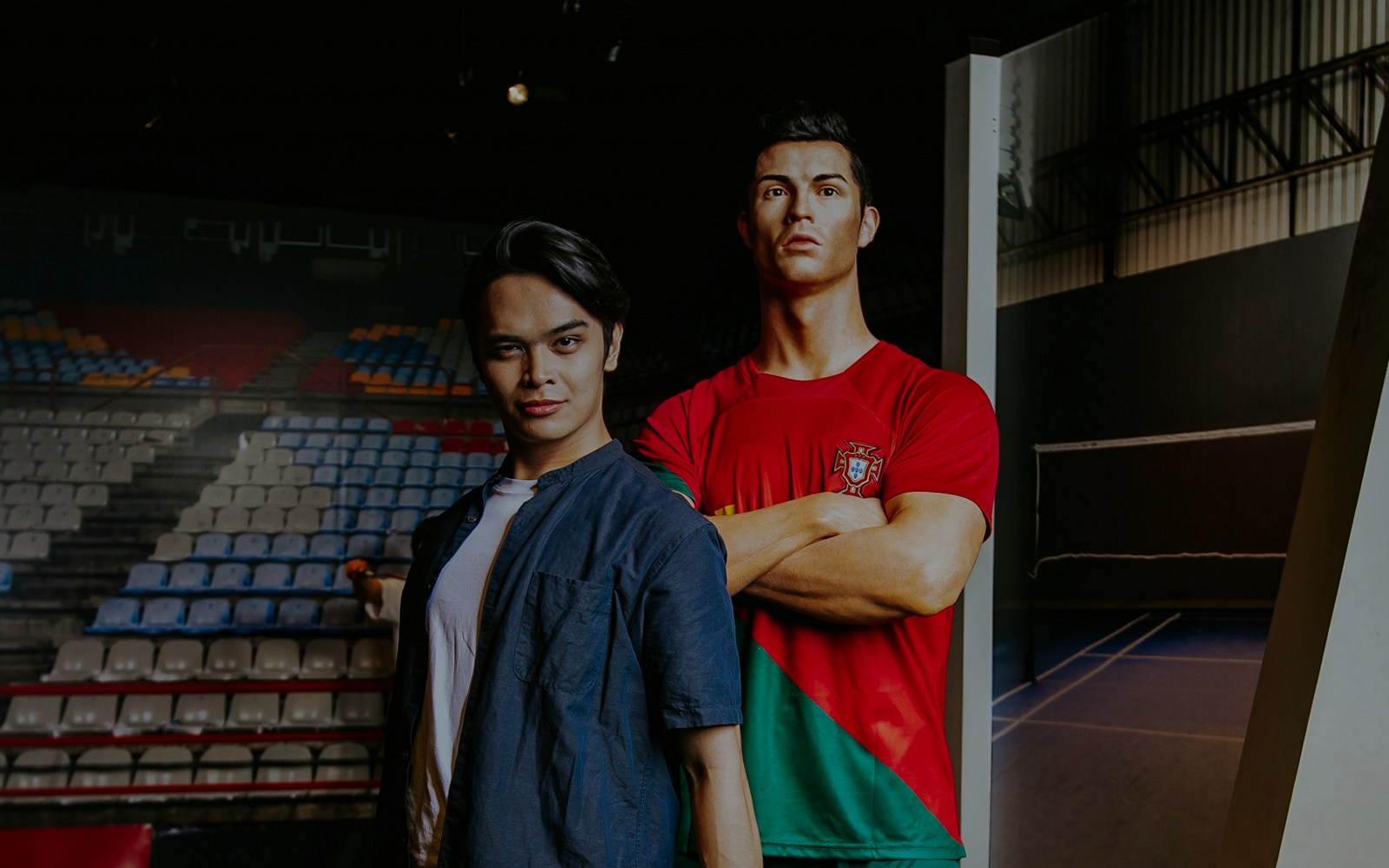 Person posing with Cristiano Ronaldo wax figure at Madame Tussauds Singapore.