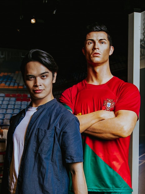 Person posing with Cristiano Ronaldo wax figure at Madame Tussauds Singapore.