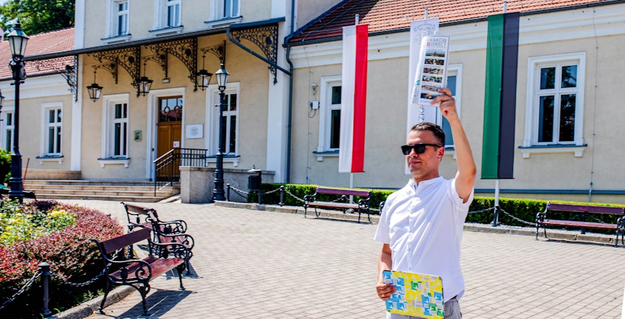 Guide holding a brochure at the entrance of Wieliczka Salt Mine, Poland.