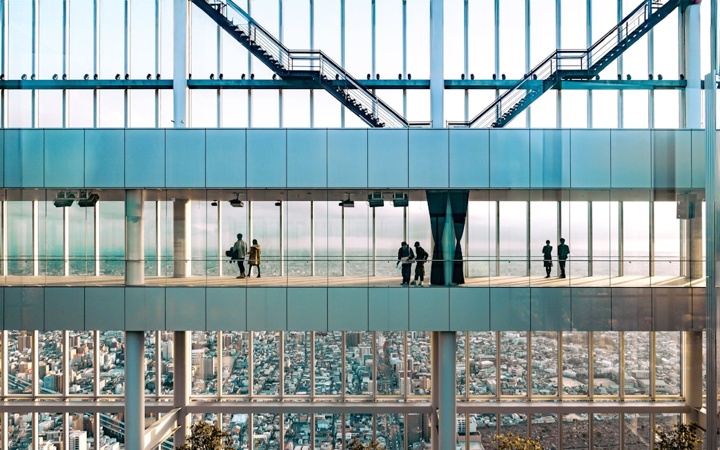 Visitors enjoying city views from Harukas 300 observation deck in Osaka, Japan.
