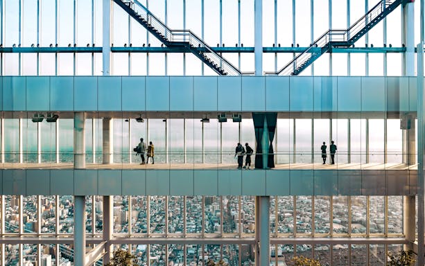 Visitors enjoying city views from Harukas 300 observation deck in Osaka, Japan.