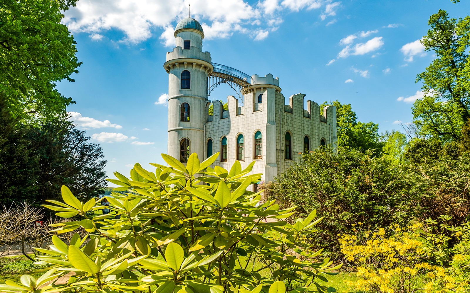 Peacock Island Palace surrounded by lush greenery on Berlin World Heritage Cruise to Potsdam.