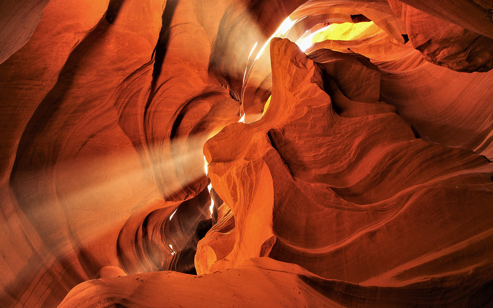 Sunlight streaming through the narrow sandstone walls of Lower Antelope Canyon.