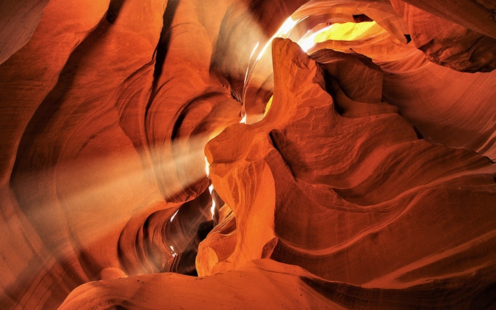 Sunlight streaming through the narrow sandstone walls of Lower Antelope Canyon.