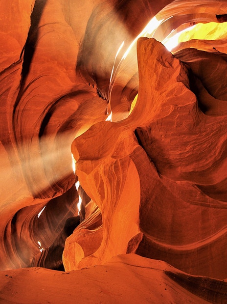 Sunlight streaming through the narrow sandstone walls of Lower Antelope Canyon.